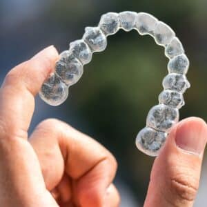 person holding their invisalign