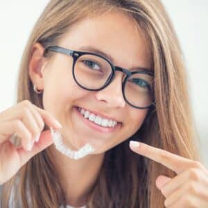 girl pointing at aligners