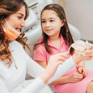 dentist explaining procedure to child