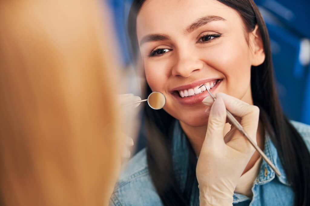 Woman smiling during her first dental visit in Charlotte, NC 28226.